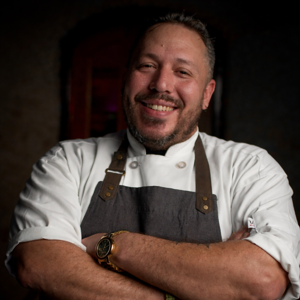 Chef Carlos Morales of Niche Restaurant greeting guests during a private dining event in San Juan, Puerto Rico