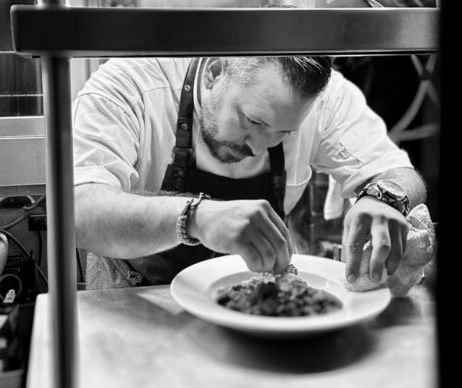 Chef Carlos Morales plating a course at Niche Restaurant San Juan — French Puerto Rican Mexican fine dining